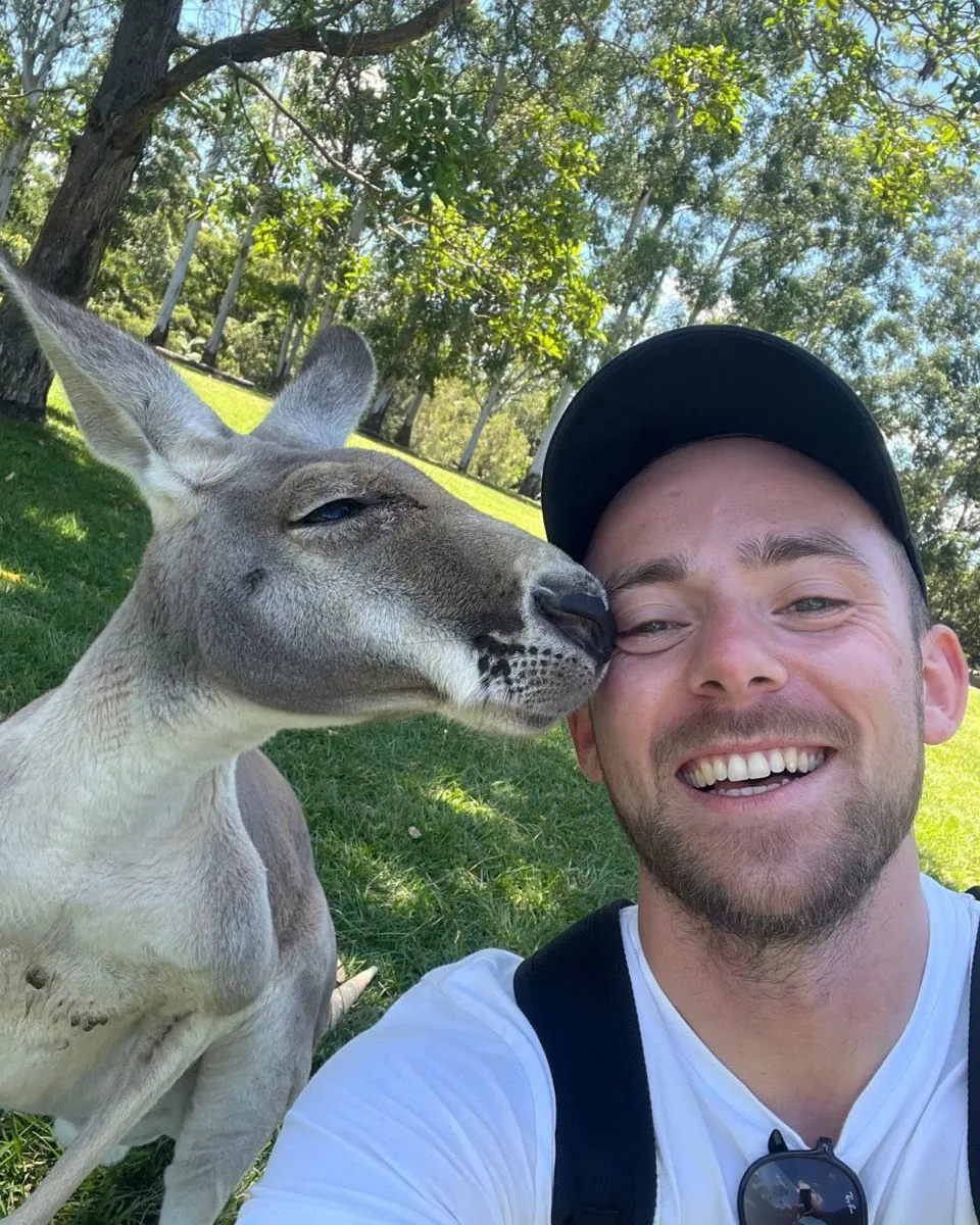 A selfie with a kangaroo nuzzling my cheek