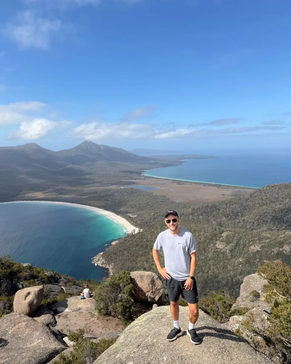 Me on the summit of Mt Amos, with Wineglass Bay behind